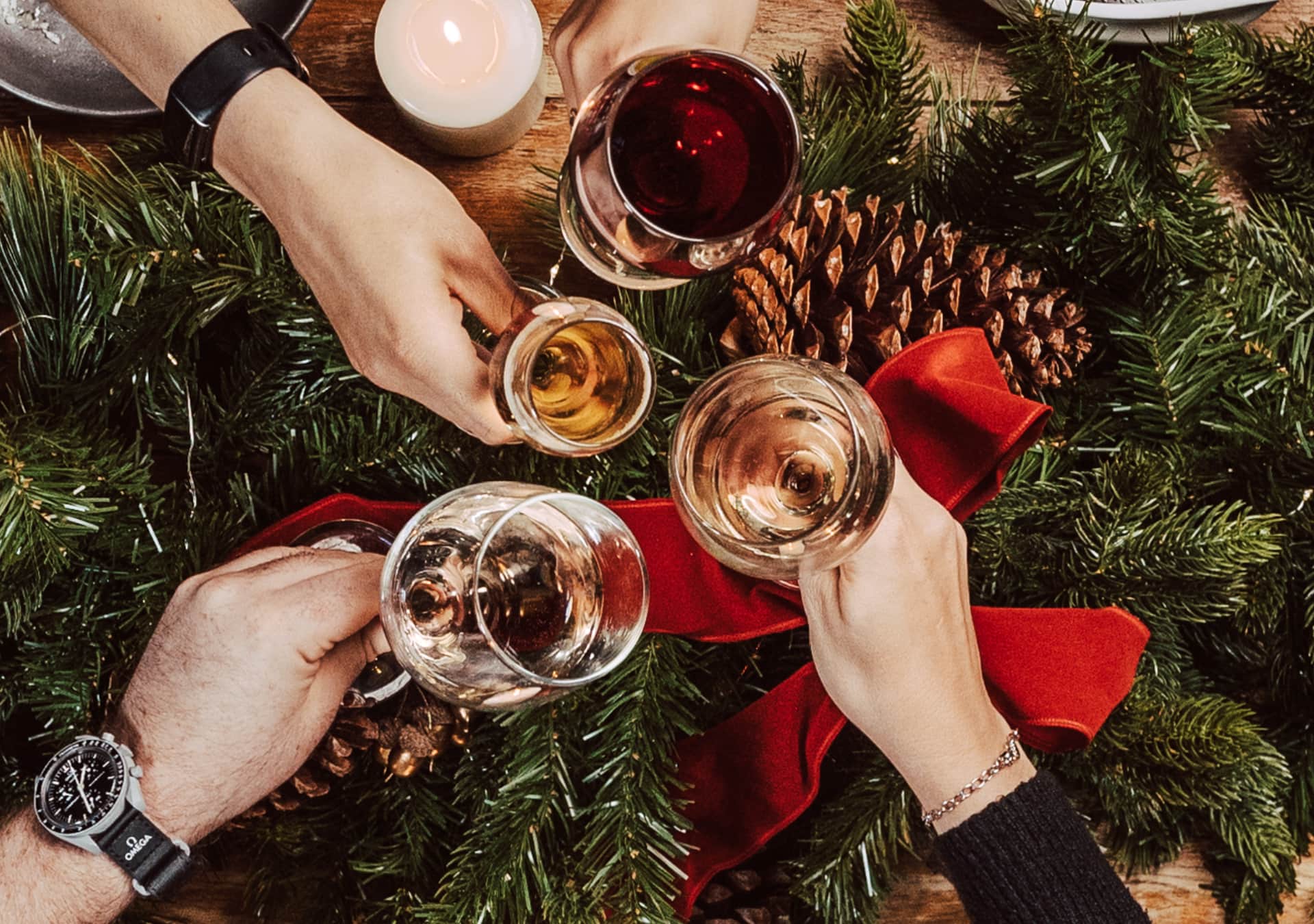 Guests toasting drinks over Christmas decorations